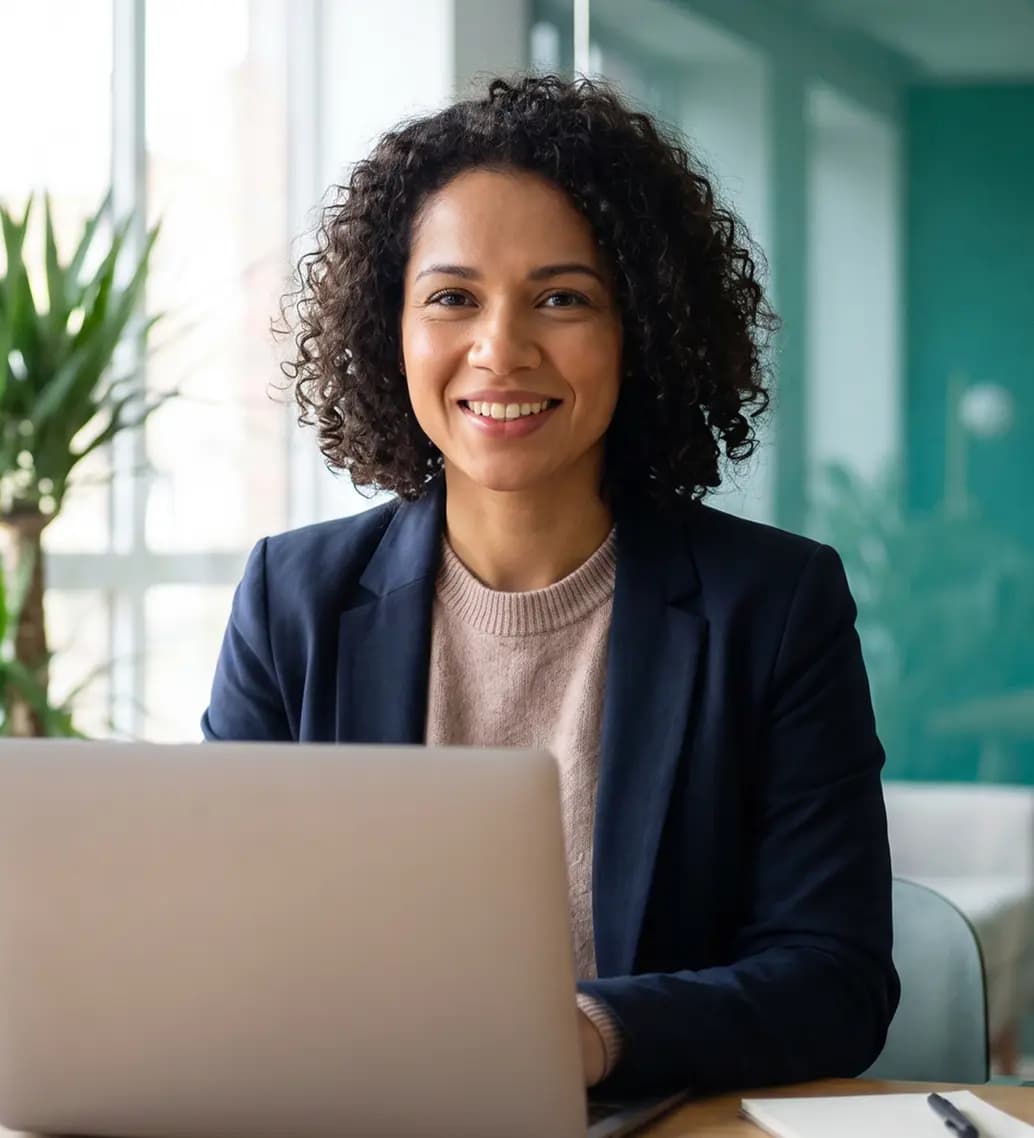 Especialista sorrindo em frente ao notebook em um escritório